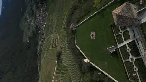 Stunning-view-of-medieval-Thun-Castle-and-its-rear-courtyard-overlooking-grassy-fields-and-orchards