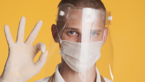 young blond guy with two protective face masks