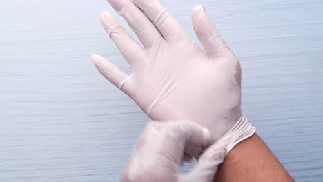 putting on medical gloves