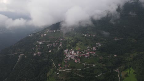 drone view of mountainside town on a cloudy and foggy day, trabzon, turkey