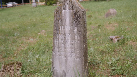 a most ancient tombstone close up view in the graveyard near the town