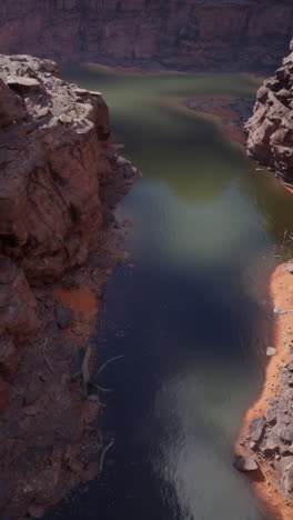 aerial view of a winding river in a red rock canyon