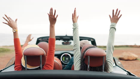friends enjoying a road trip in a convertible