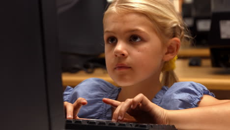 cute pupil using computer in school