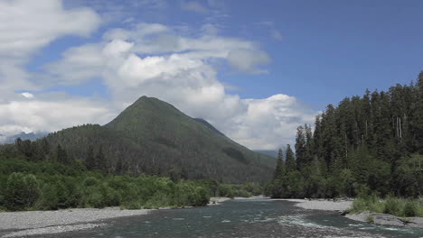 Time-lapse-of-clouds-passing-over-a-forest-mountains-and-río