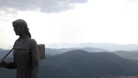 Aerial-shot-of-1940-Women-of-Epirus-statue-on-a-cloudy-day