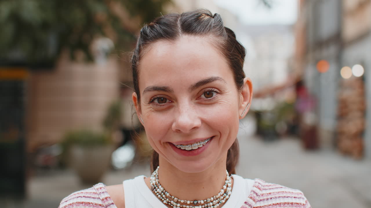 Portrait of happy woman face with braces on teeth smiling open eyes glad expression looking dreaming