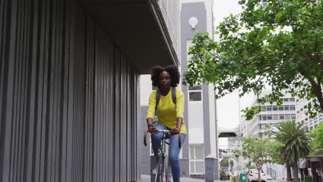 African-american-woman-riding-bicycle-in-street