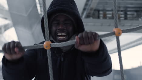 angry man pulling ropes outdoors