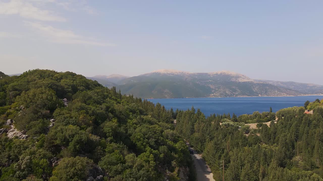 Ascent following car driving through mountains at Church of Panagia Sia in Greece