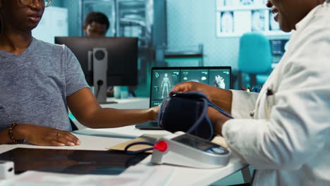 female physician expert measuring blood pressure at a consultation with girl