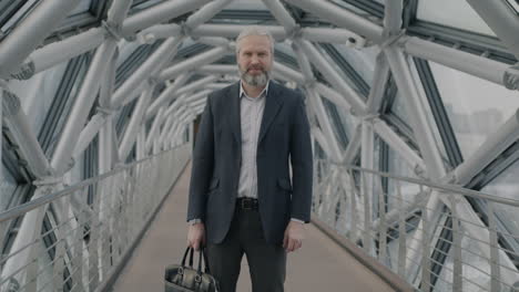 businessman walking on modern pedestrian bridge