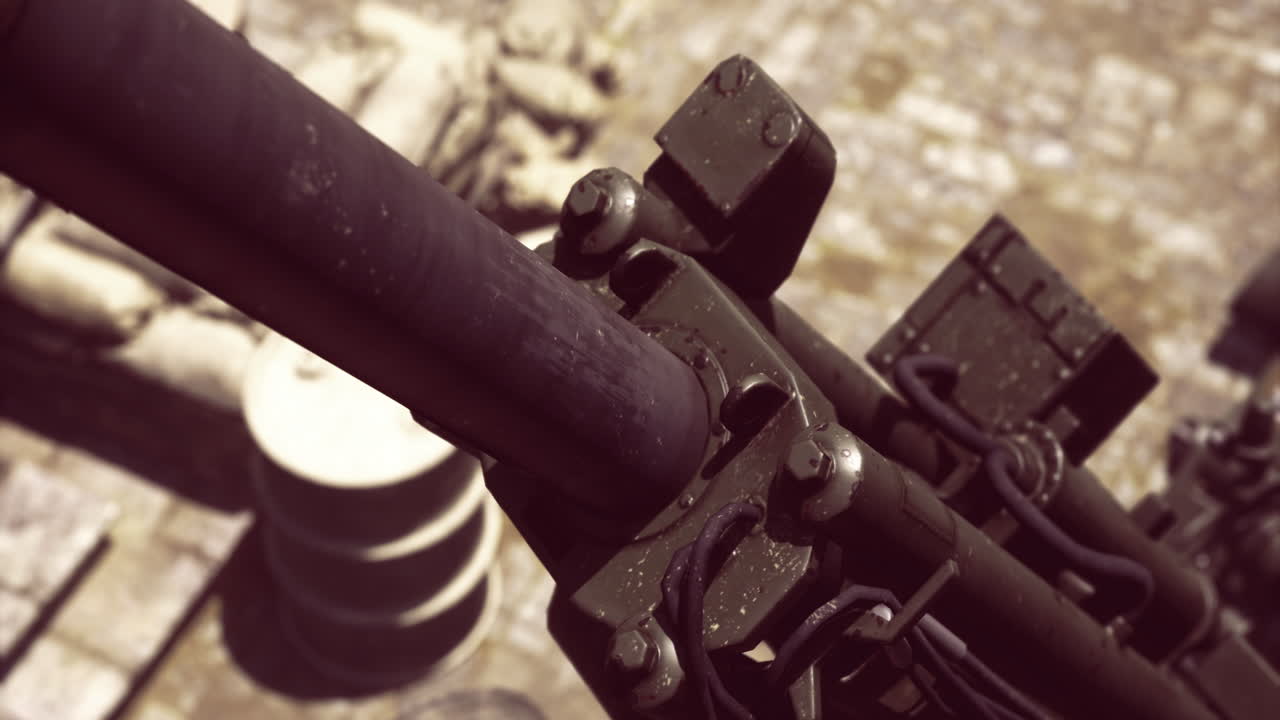 Detailed view of a military gun resting on the ground in a combat area