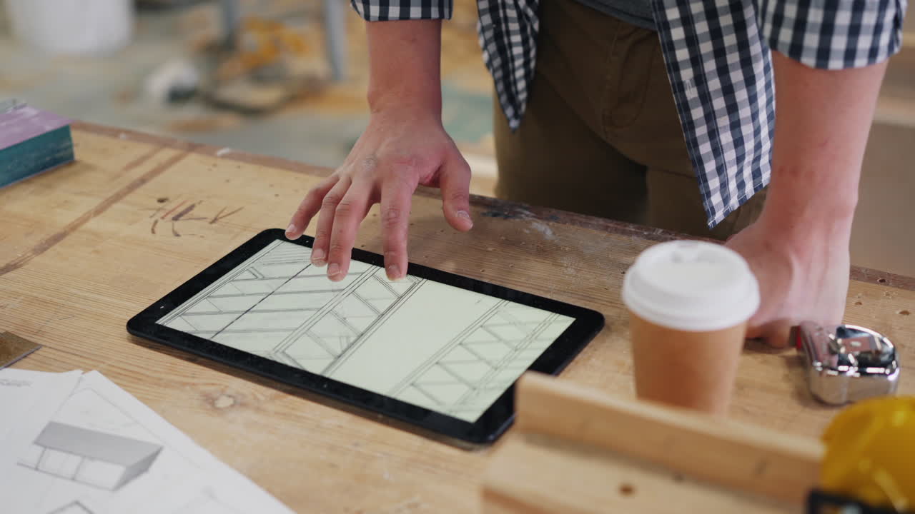 Woodworker Designing Furniture Plans on a Tablet