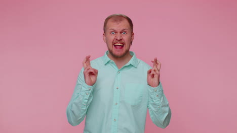 Stylish-man-in-shirt-shouting,-raising-fists-in-gesture-I-did-it,-celebrating-success,-winning