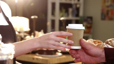 waitress serving a coffee to customer