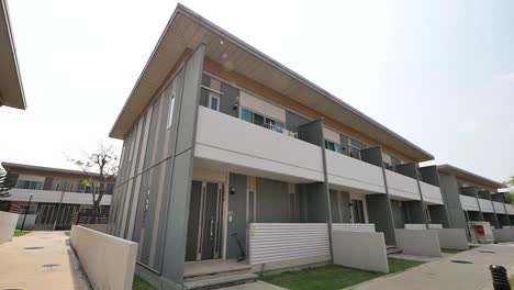 beige and brown modular home exterior design, day