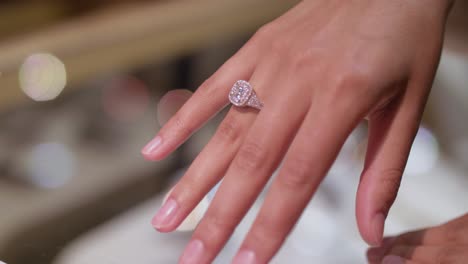 bride is trying beautiful diamond before wedding ring in the jewelry store