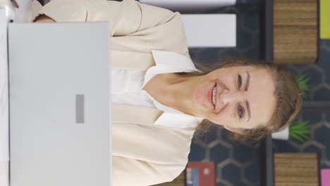 Vertical-video-of-Business-woman-working-on-laptop-gets-satisfied.