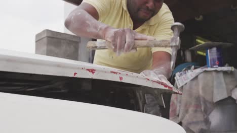 african man repairing car