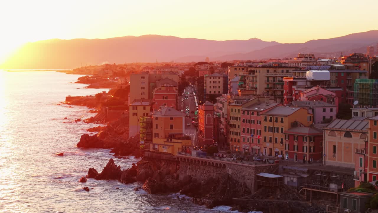 Golden hour over Genoa’s coastline, showcasing vibrant buildings along the Mediterranean