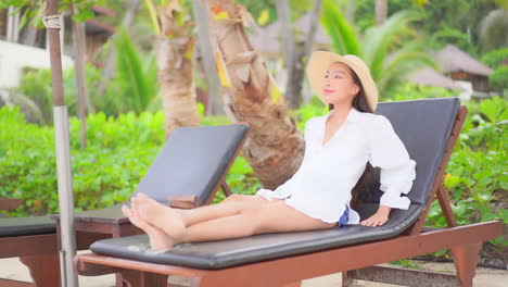 Woman-relaxing-on-a-deckchair-enjoying-vacation-time-in-Tropical-hotel-in-Cancun