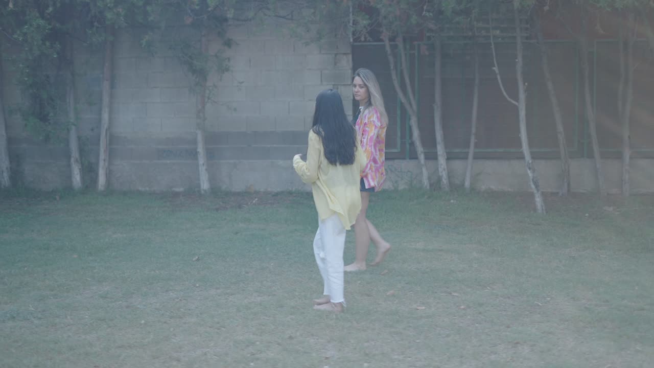 Two Women Walking in a Garden