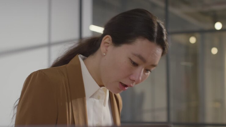Businesswoman Interviewing Off Camera Candidate For Job In Office 2