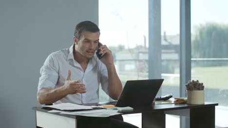 Business-man-yelling-on-mobile-phone-in-house.-Angry-man-screaming-on-phone.