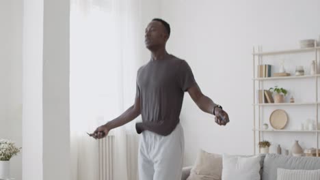 man jumping rope at home