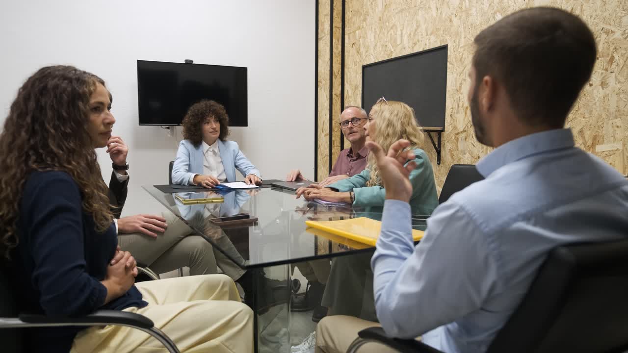 Businesspeople brainstorming over project during conference meeting in office