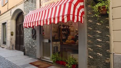 a quaint shop with striped awning