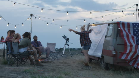 friends camping party by the van