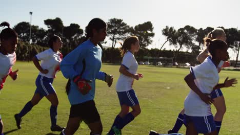 Female-soccer-team-running-lapse-on-soccer-field.-4k