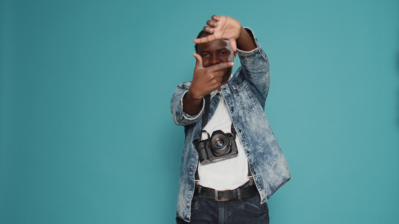 Photographer doing photo frame gesture with fingers