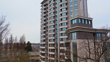new multy-storey building in the city outside. beautiful modern high-rise public housing apartments. camera moves forward.