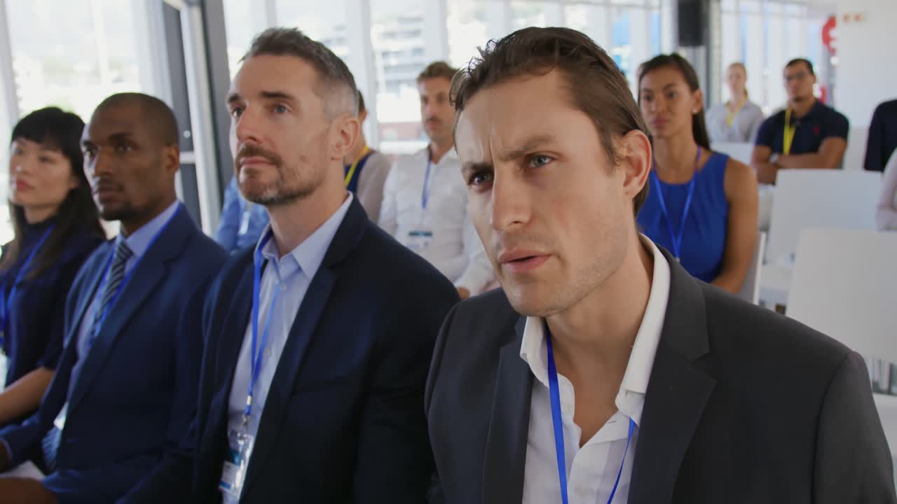 Businessman asking a question at a seminar