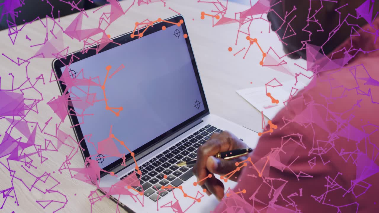 Senior man moving pen to laptop keys, preparing tech input, pink confetti drifting over him