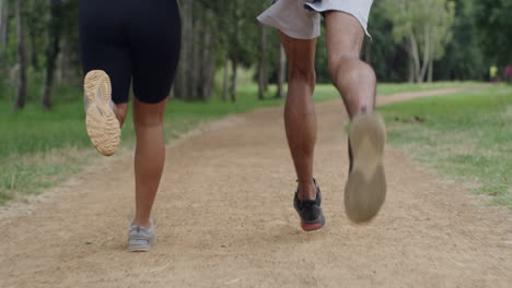 Closeup-of-fit-couple-legs-running-on-a-forest