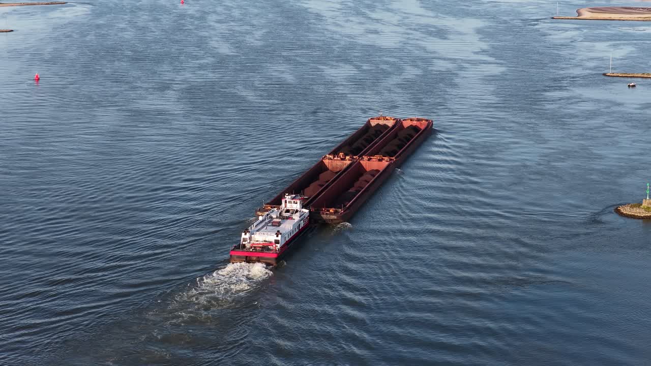 Bulk transport over inland waterway. Over the Waal river, aerial drone view
