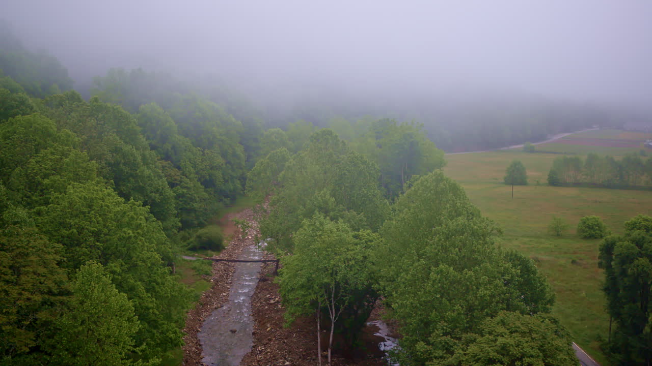 Ethereal clouds weave through the Smoky Mountains in a cinematic aerial sweep