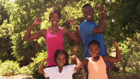 cute family is showing their muscle to the camera