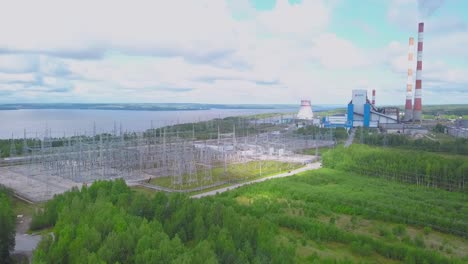 aerial view of a power plant and substation near a river