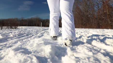 a close up of a girl walking through deep snow