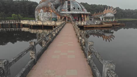 Reveal-shot-of-big-dragon-at-Abandoned-waterpark-Hue-Vietnam,-aerial