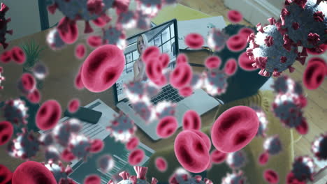 animación de células de covid-19 y glóbulos rojos sobre una mujer de negocios usando una computadora portátil