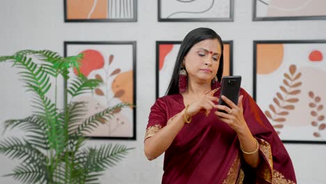 Annoyed-Indian-woman-scrolling-phone