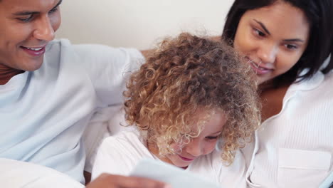 parents reading a book for their child