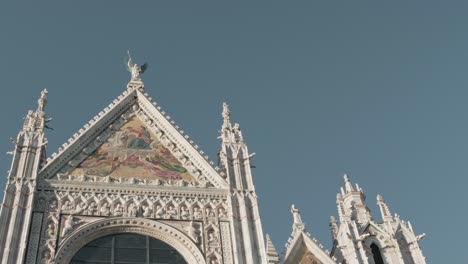 a skyward view of the famous duomo in siena, italy