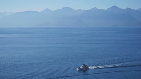 full shot, boat sailing the mediterranean sea, toros mountain range in the background